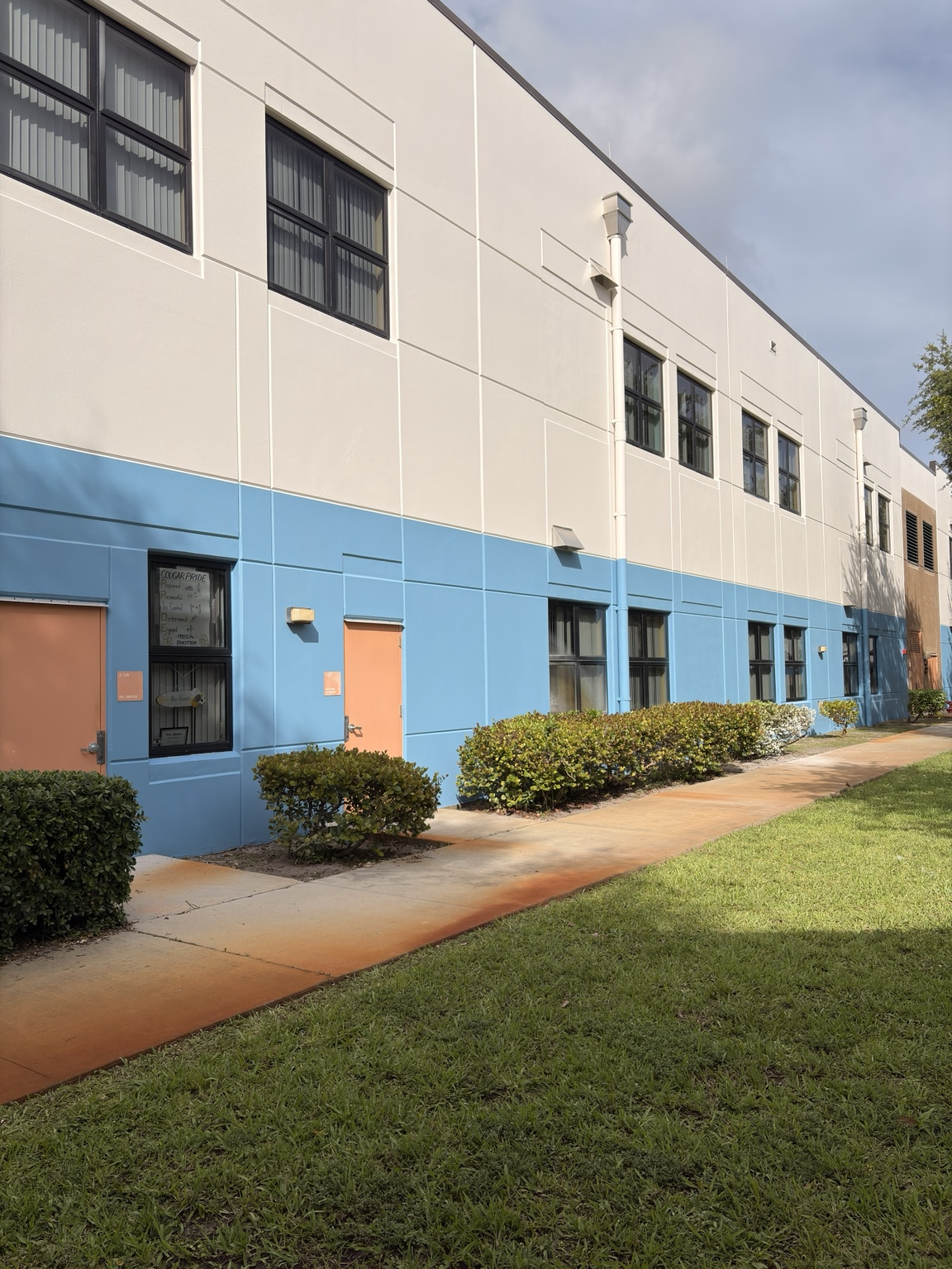 Commercial building exterior after repainting with white and blue finish